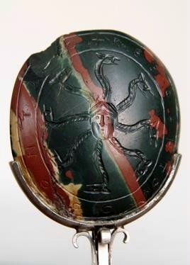 A jasper stone with a drawing of a seven-pointed snake symbol.