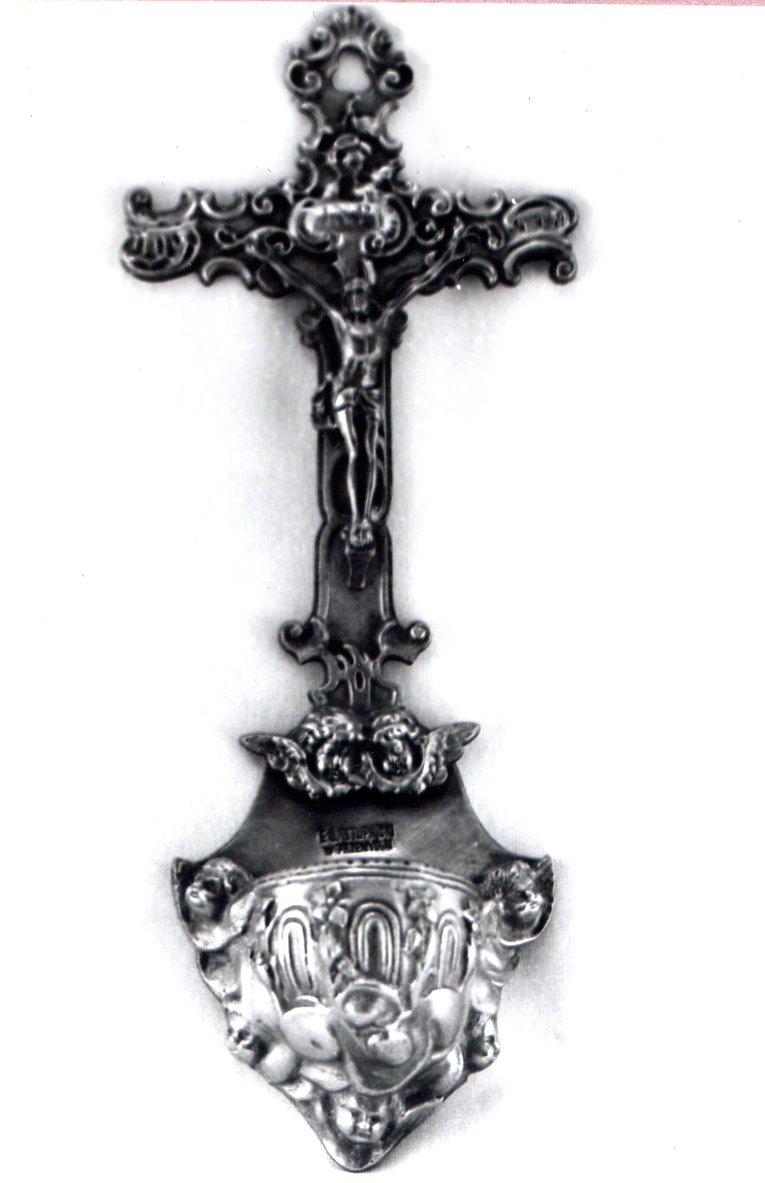 Silver crucifix with a holy water bowl, decorated with angel motifs and floral ornaments.
