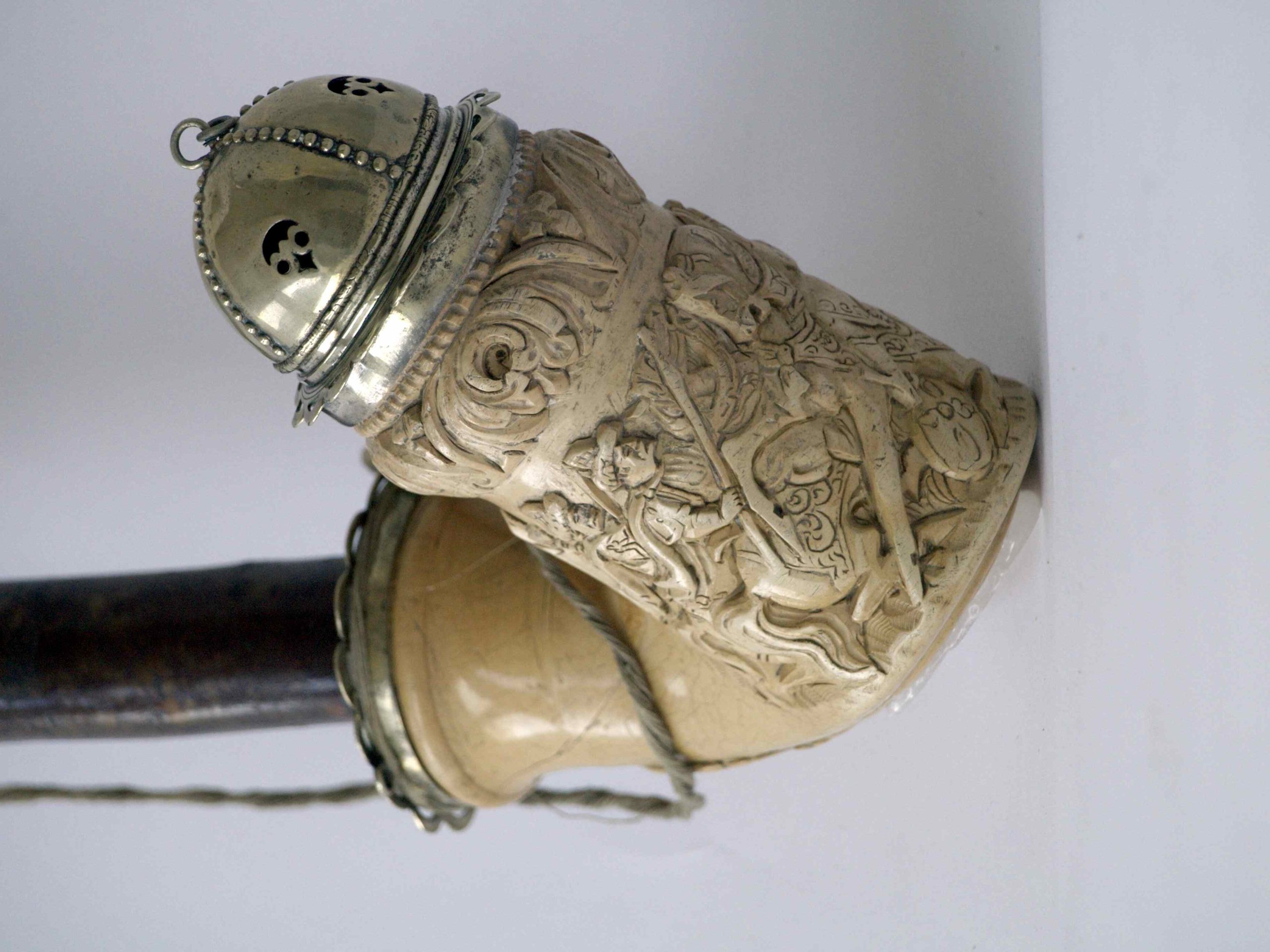 Pipe with a carved, richly decorated bone bowl and metal cap.