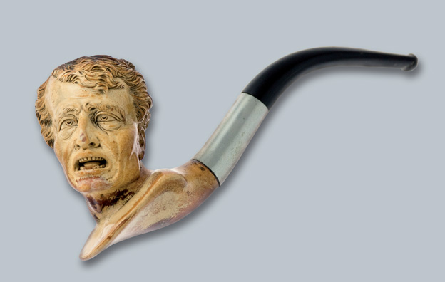 A pipe with a bowl in the shape of a man's head with a distinctive, expressive face, and a black, curved mouthpiece.