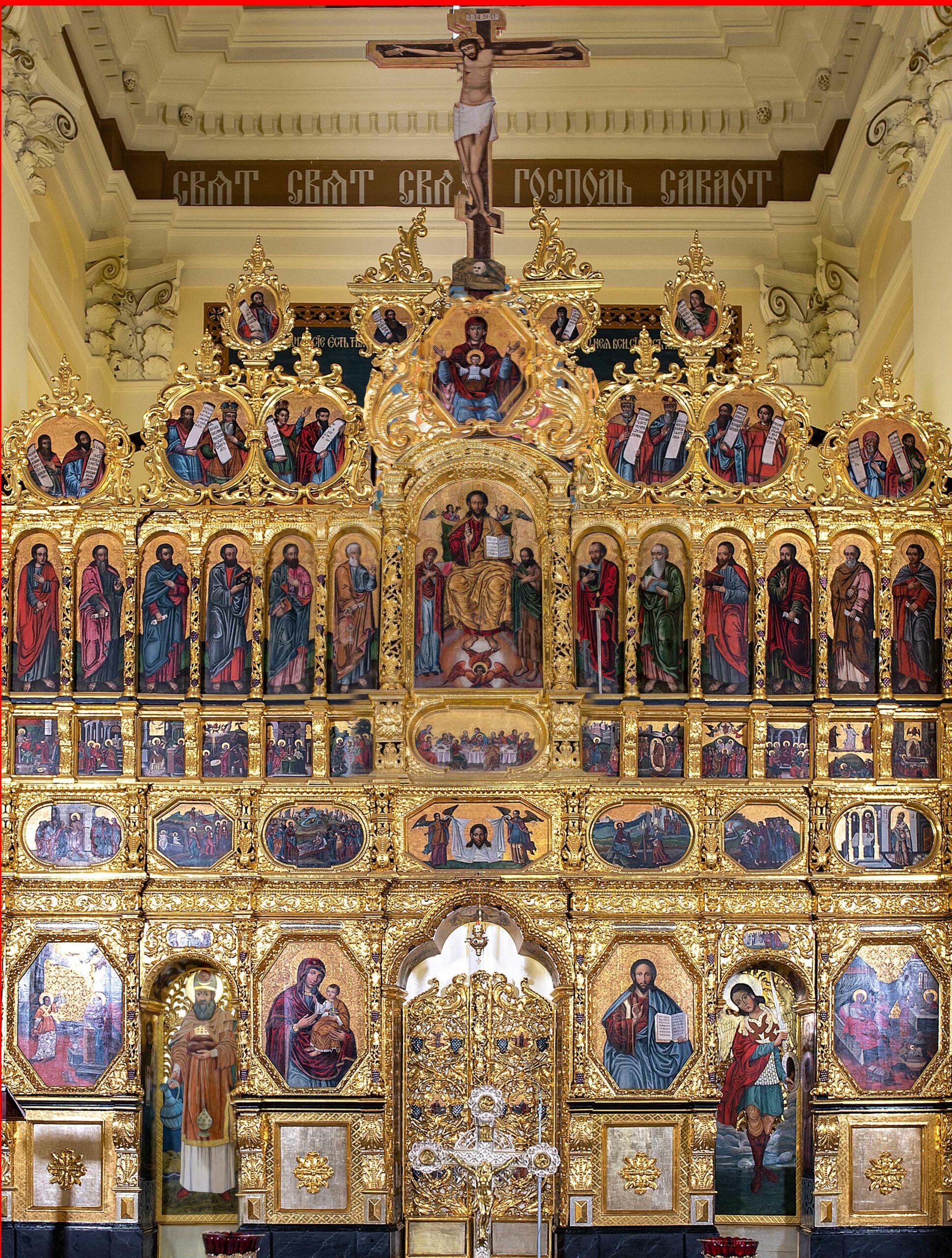 Richly gilded church iconostasis with many icons of Christ, the Mother of God, the apostles and biblical scenes.