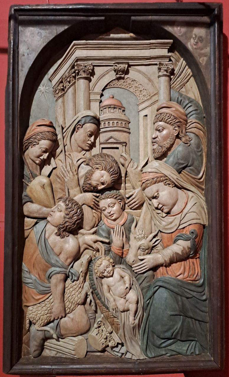 Polychrome bas-relief depicting a Christmas scene with Mary, the Child and surrounding figures.