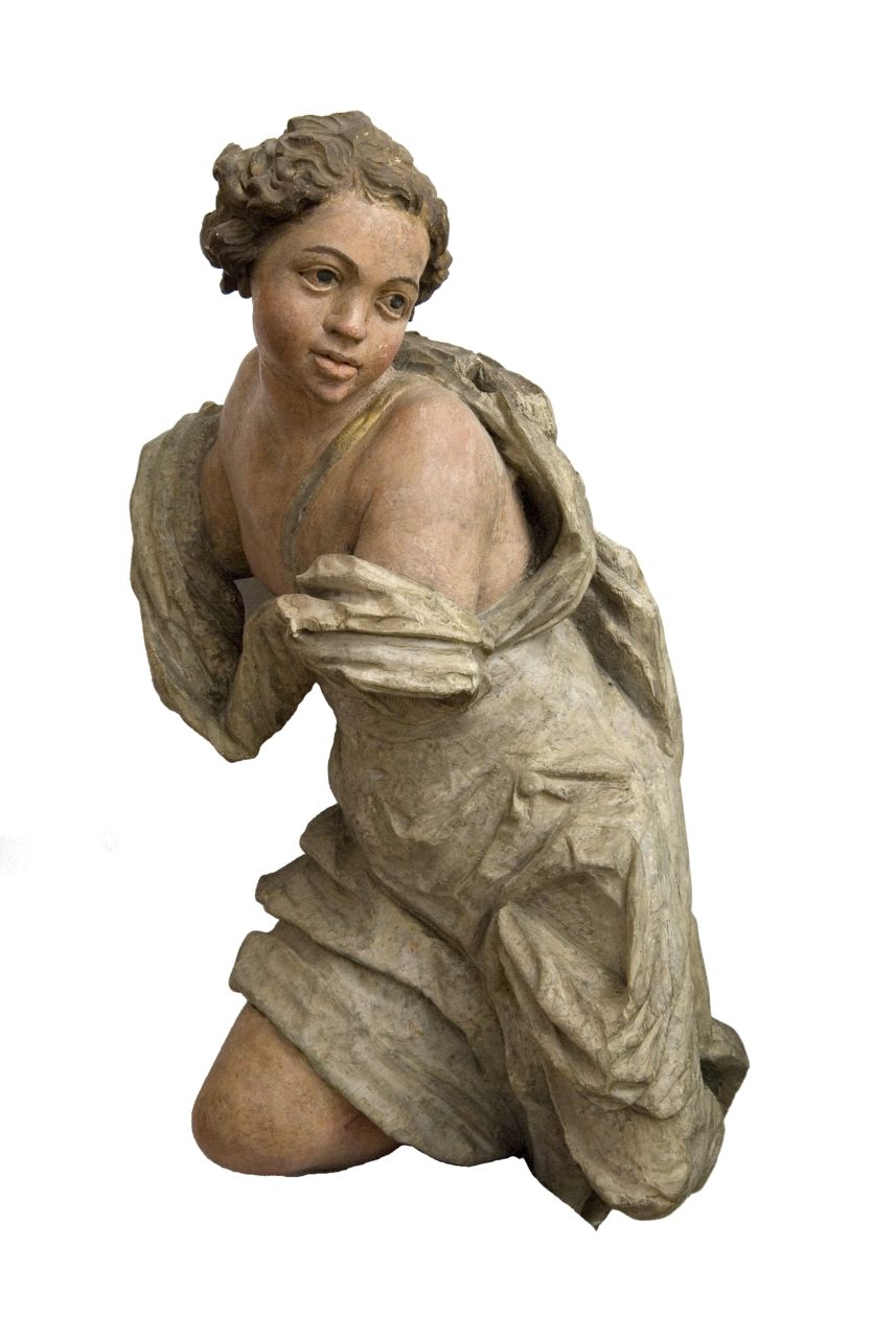A polychrome sculpture of a kneeling female figure in a dynamic pose, a fragment of an old sculptural composition.