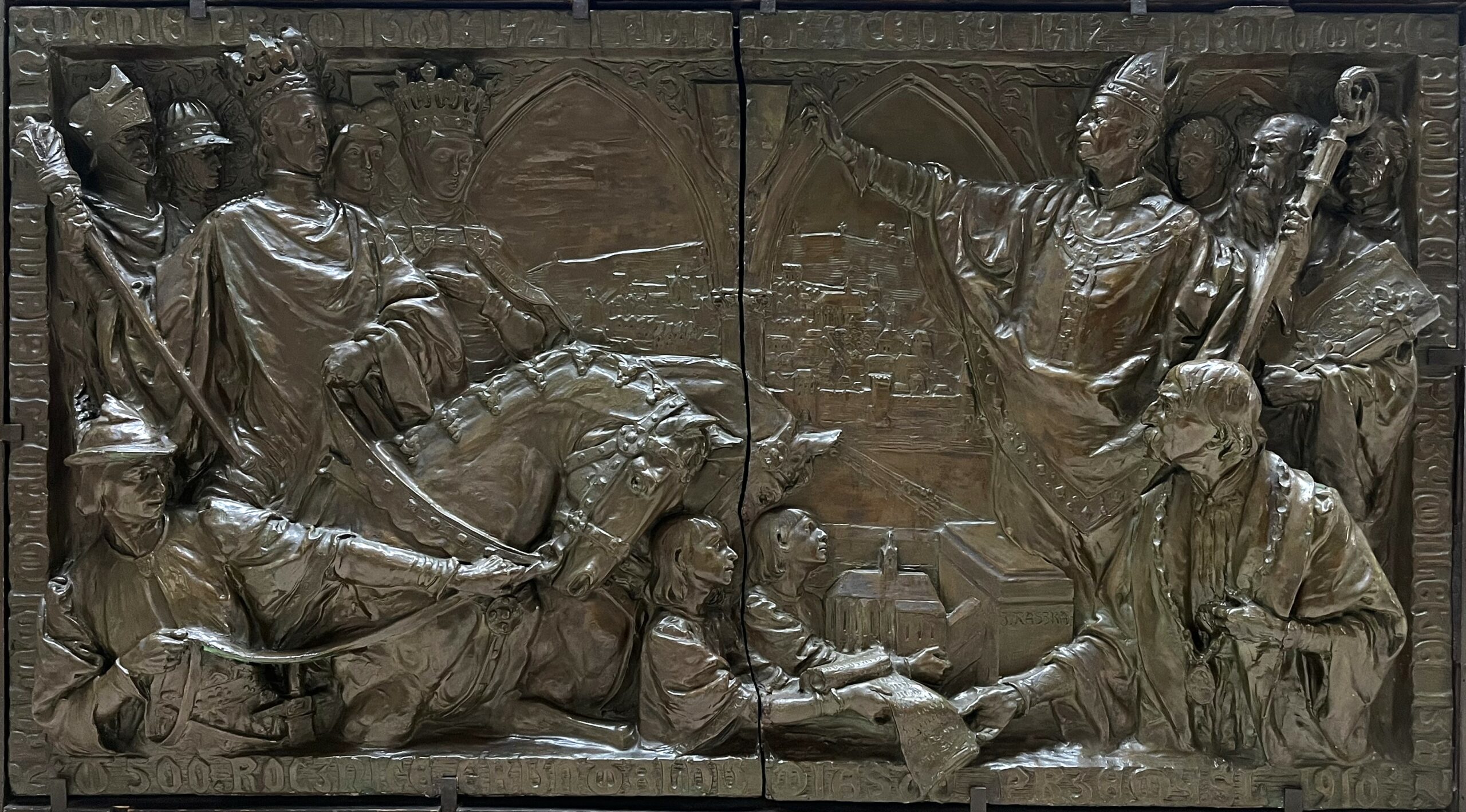 Bronze historical bas-relief depicting a ceremonial scene with the participation of clergy, rulers and city residents.