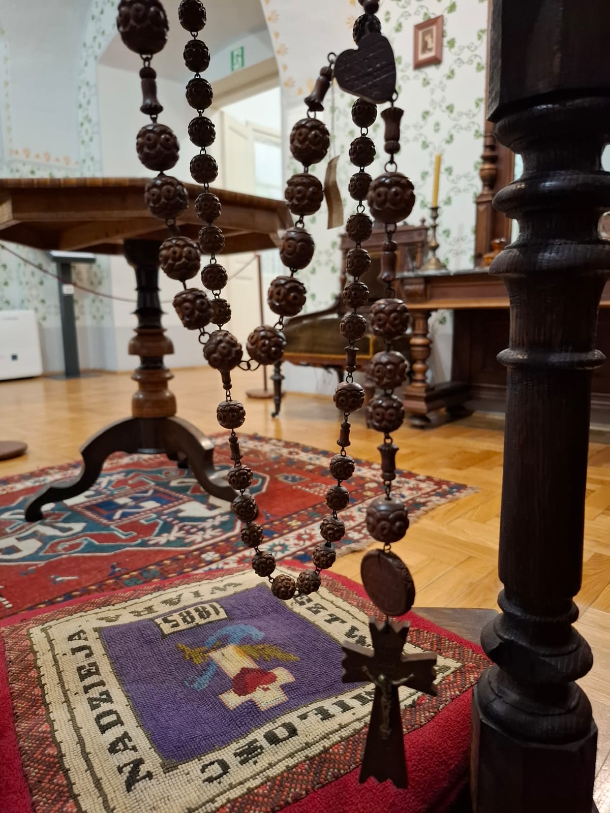 Wooden rosary with carved beads and a cross.